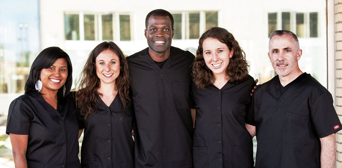 Dr. Nettey-Marbell and our friendly dental team smiling outside the office