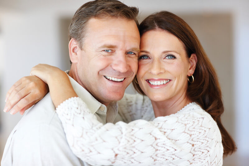 Couple showing results of teeth whitening