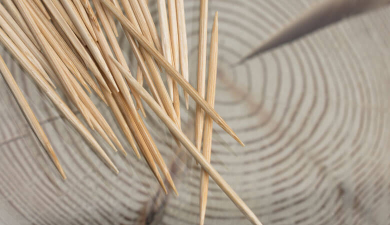 pile of toothpicks on wood