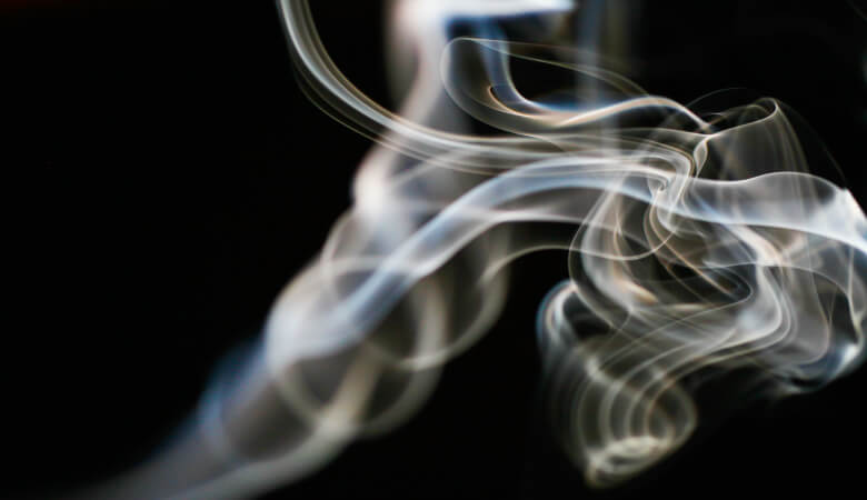 A wisp of tobacco smoke against a black background