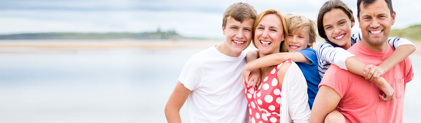 Family members showing off teeth whitening results