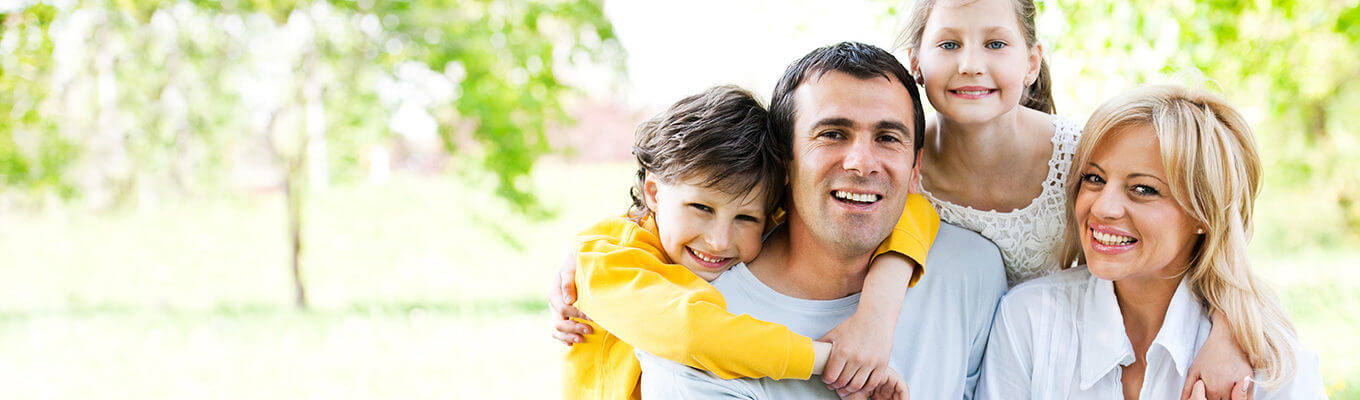 Family members smiling in a park