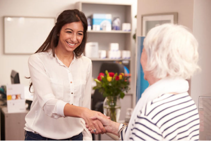 dental assistant welcomes a patient for comprehensive dental care