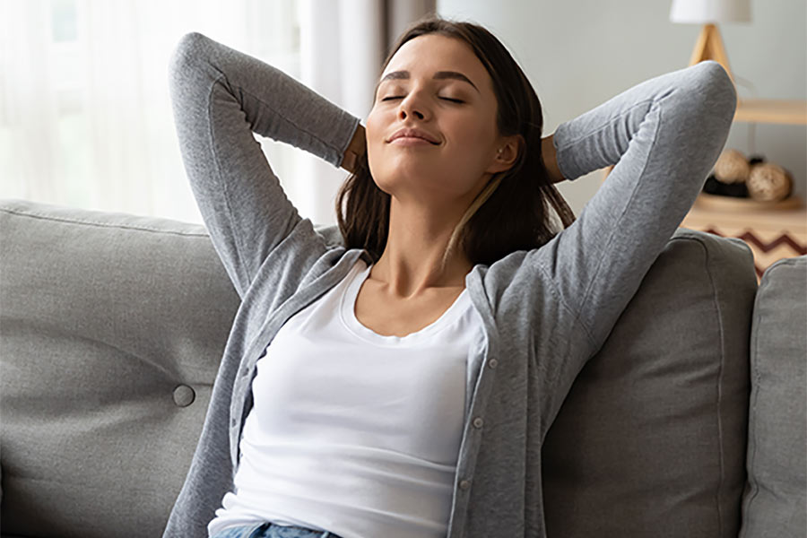 young woman meditating to alleviate teeth grinding