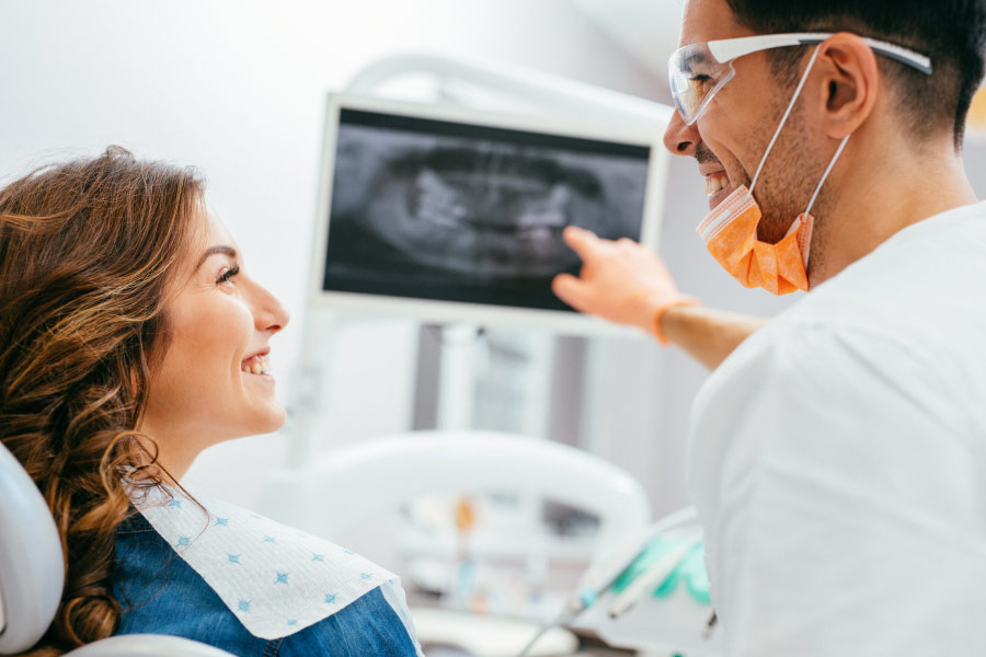 dentist shows a female patient her digital dental x-ray