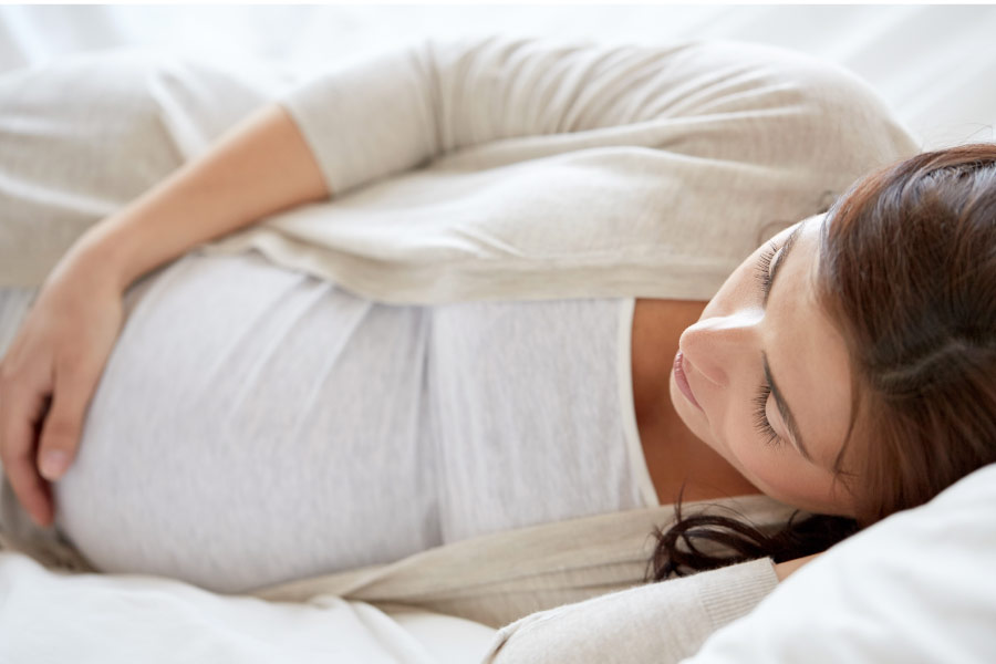 pregnant woman laying on her side