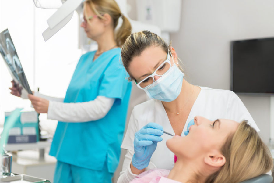woman getting a routine dental cleaning and exam
