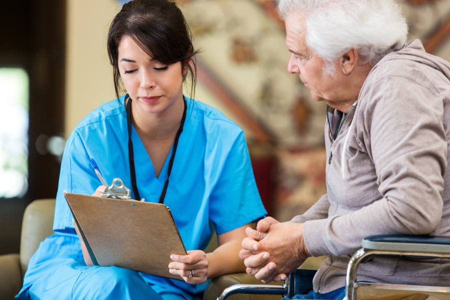 dentist talks to a senior man about his dental anxiety