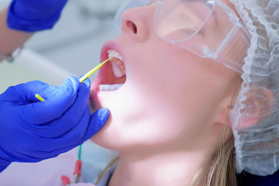 patient getting a fluoride treatment at the dentist